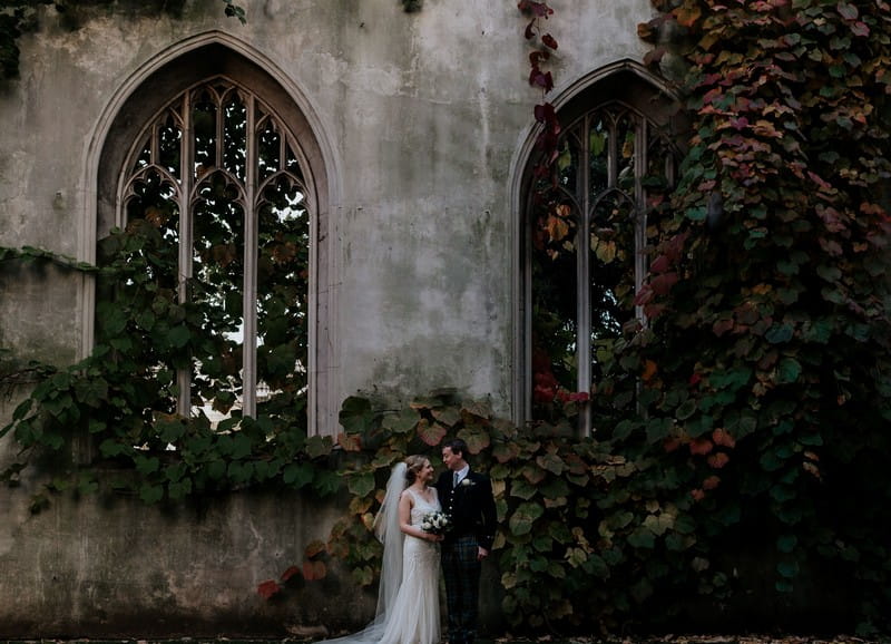 Bride and groom standing in front of St Dunstan Chapel ruins - Picture by Emily Black Photography