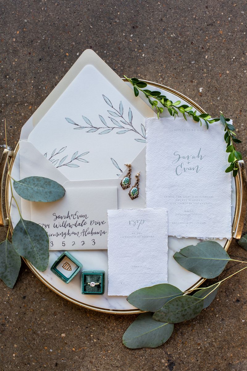 Wedding stationery with foliage detail on gold rimmed tray