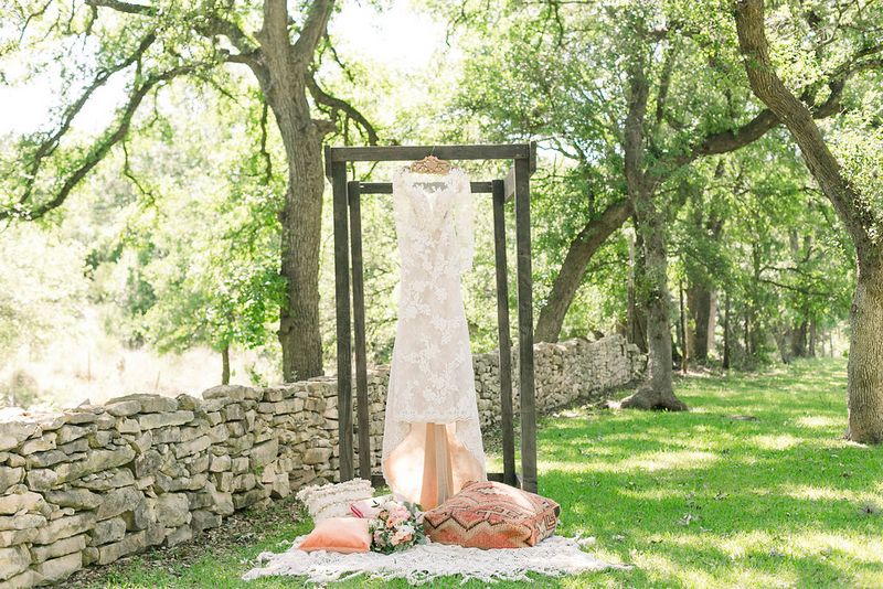 Wedding dress hanging over patterned cushions