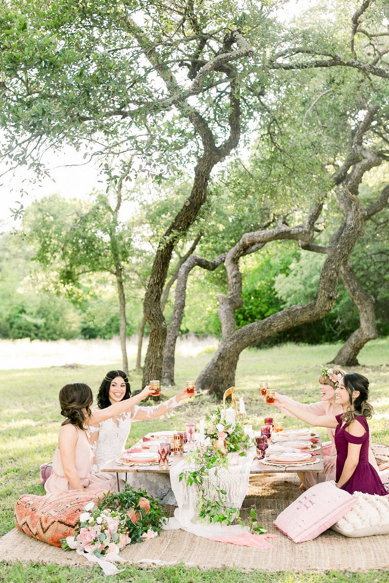 Girls sitting at low-level table for outdoor bridal shower