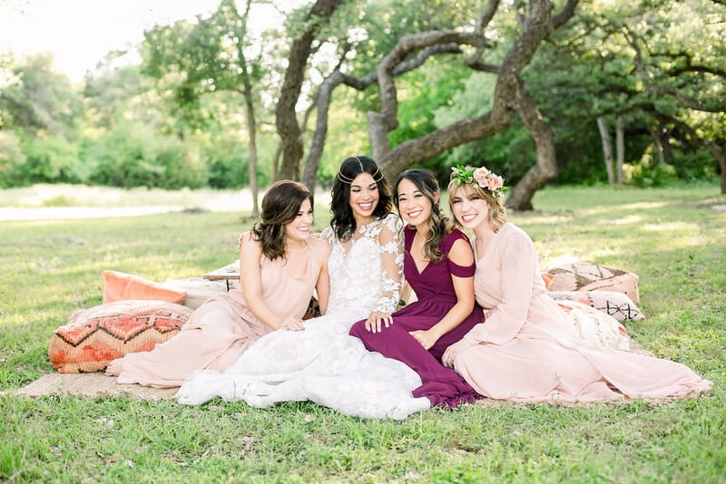 Bride-to-be and friends sitting on grass