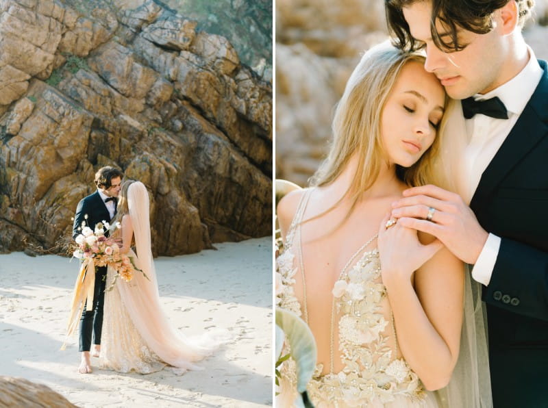 Bride and groom on beach by rocks