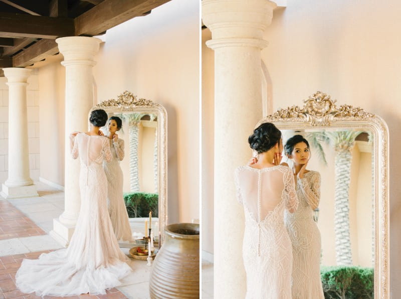 Bride looking in floor length mirror