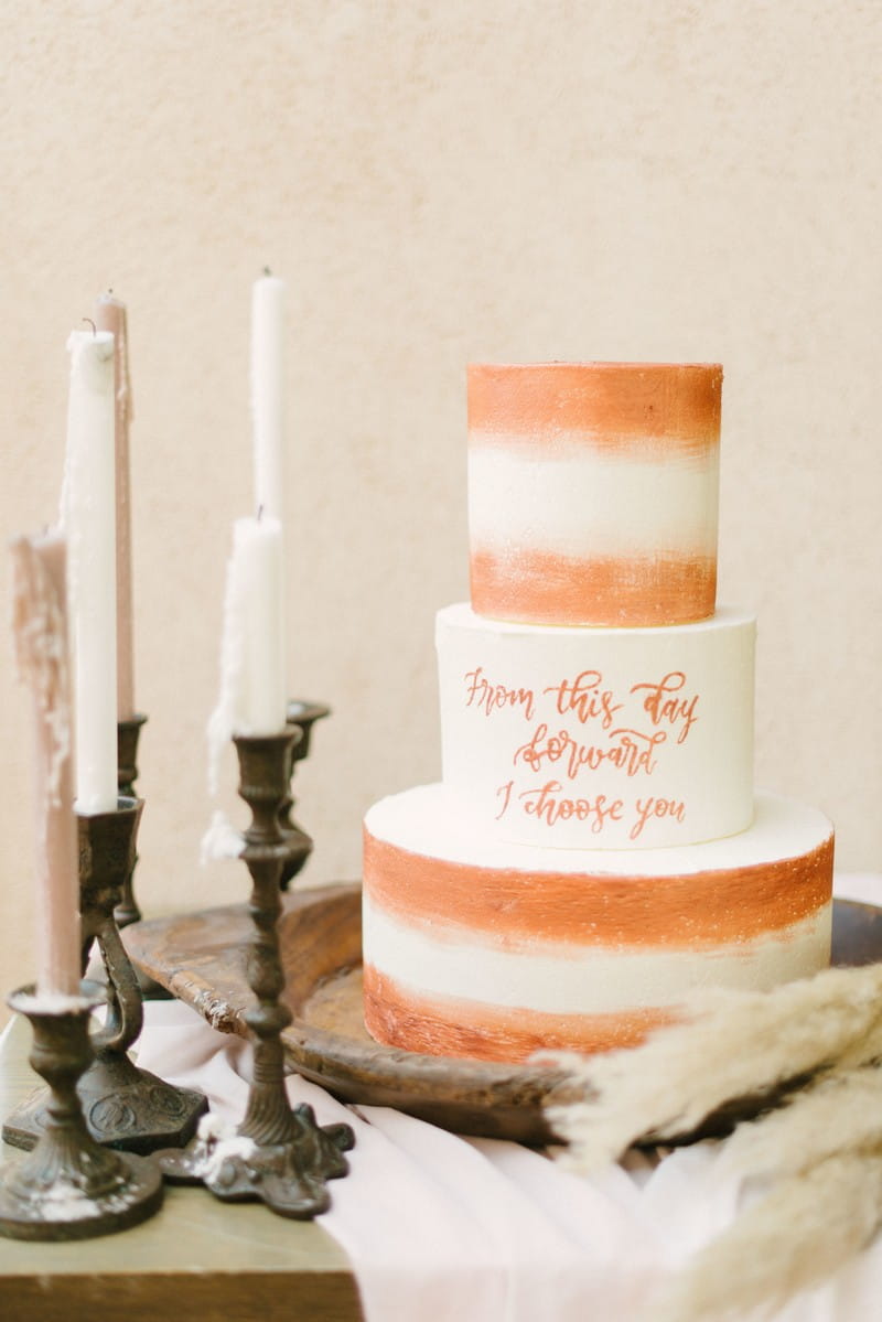 Wedding cake with terracotta coloured detail and lettering