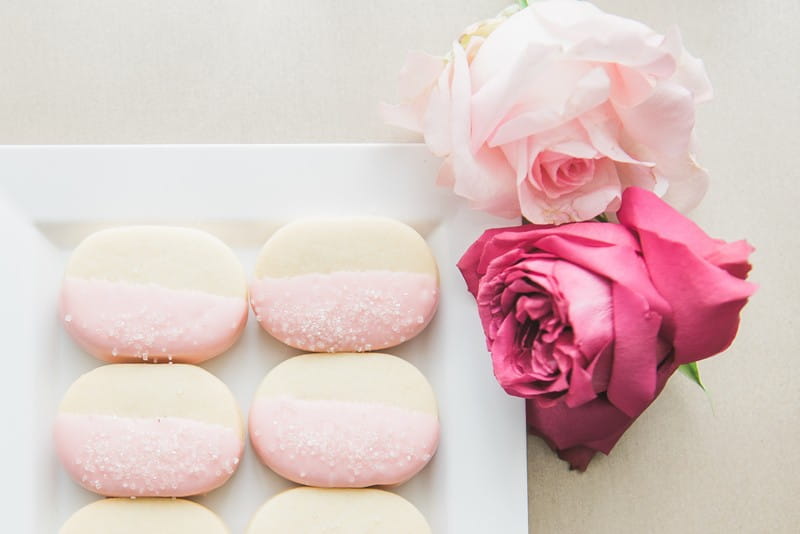 Pink iced shortbread biscuits with roses
