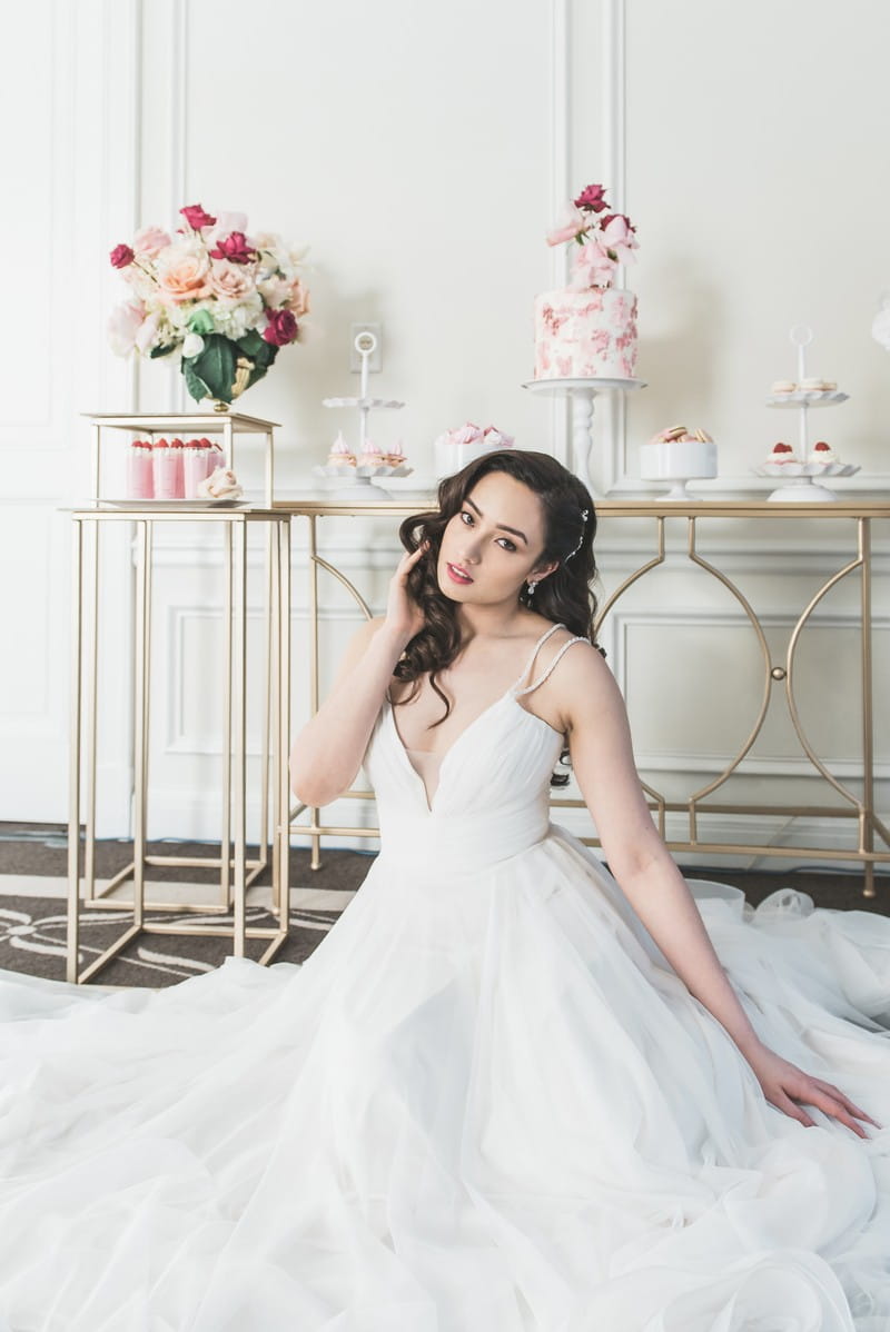 Bride sitting in front of dessert table