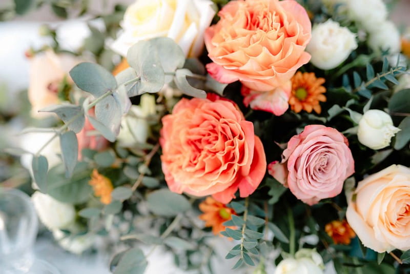 Orange and blush wedding table flowers