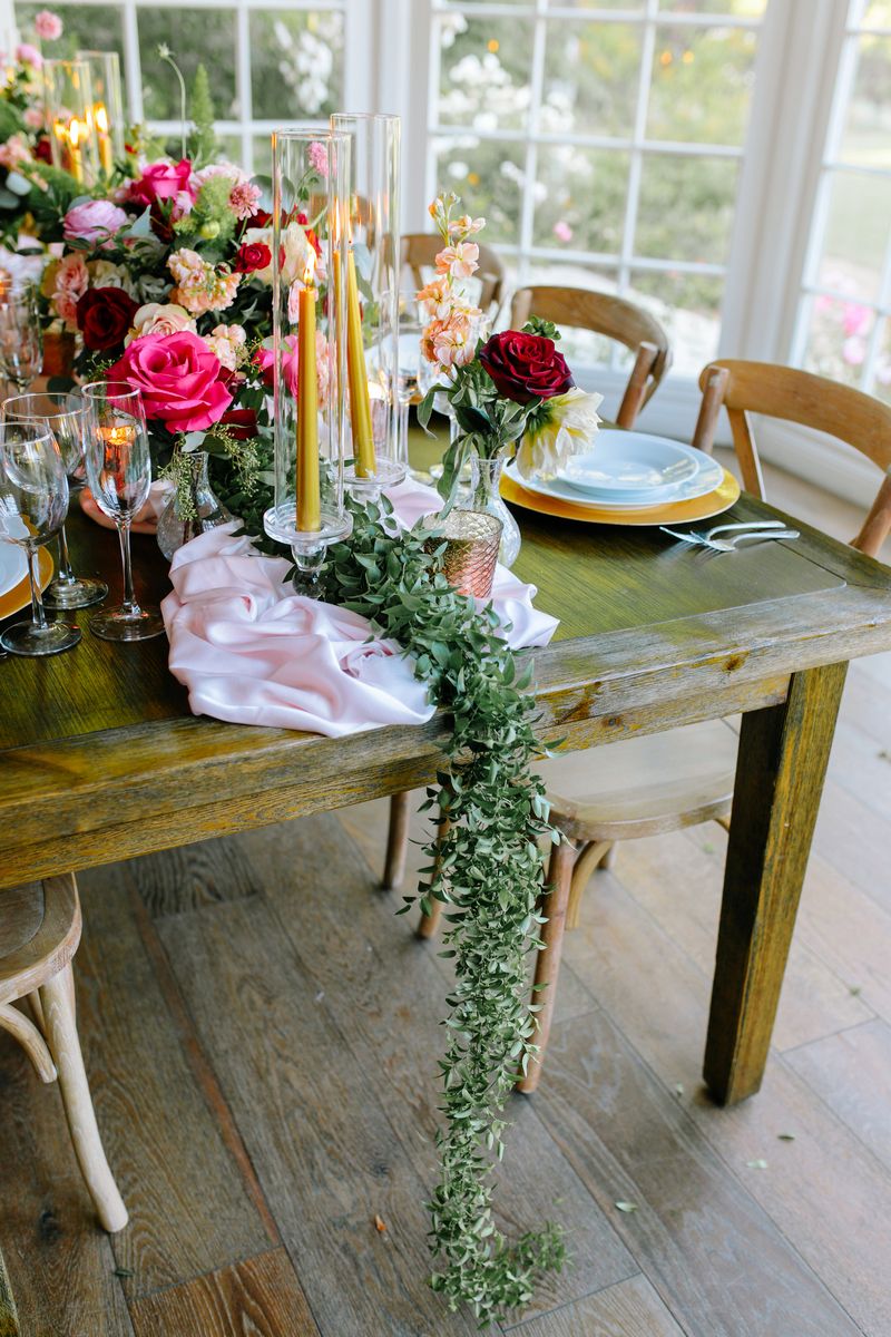 Green foliage runner hanging off wedding table