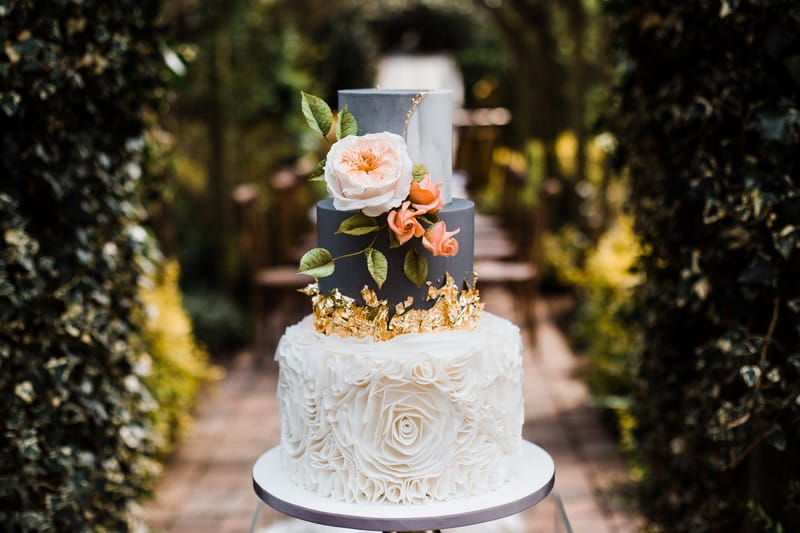 Grey and white marble wedding cake with gold leaf