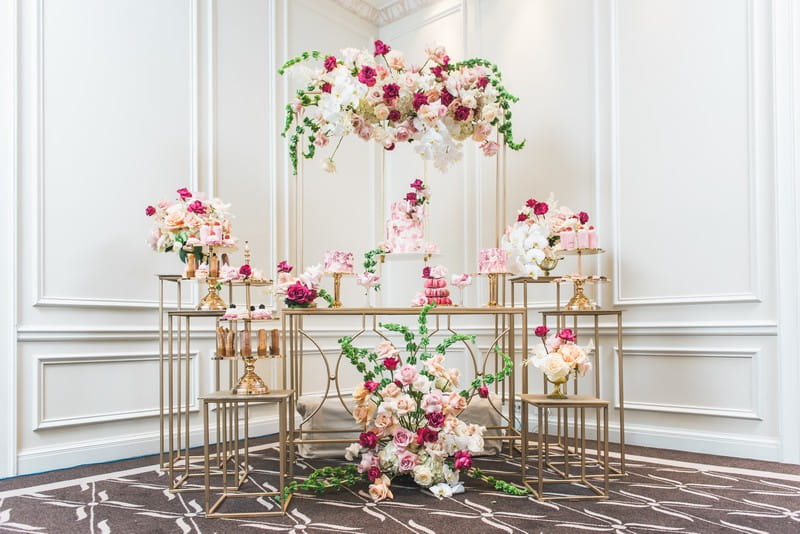 Elegant pink and gold dessert tables styled with flowers