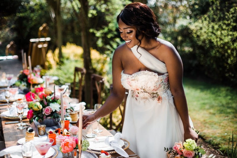 Bride smiling standing by wedding table