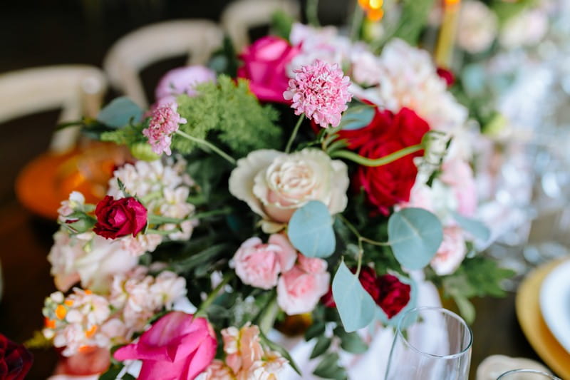 Wedding floral arrangement with burgundy, pink and white flowers