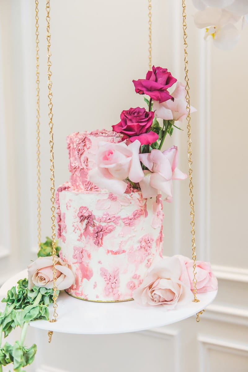 Hanging pink wedding cake suspended by chains