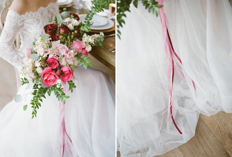 Burgundy and pink wedding bouquet with ribbon trailing down tulle skirt