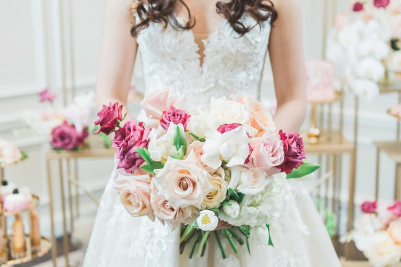 Bride holding bouquet of pink and cream flowers