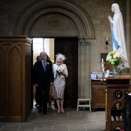 Excited lady walking into church for wedding ceremony - Picture by Simon Dewey Photography