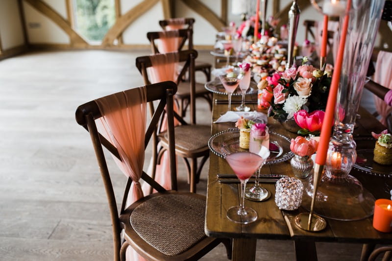 Wedding chairs with coral coloured sashes