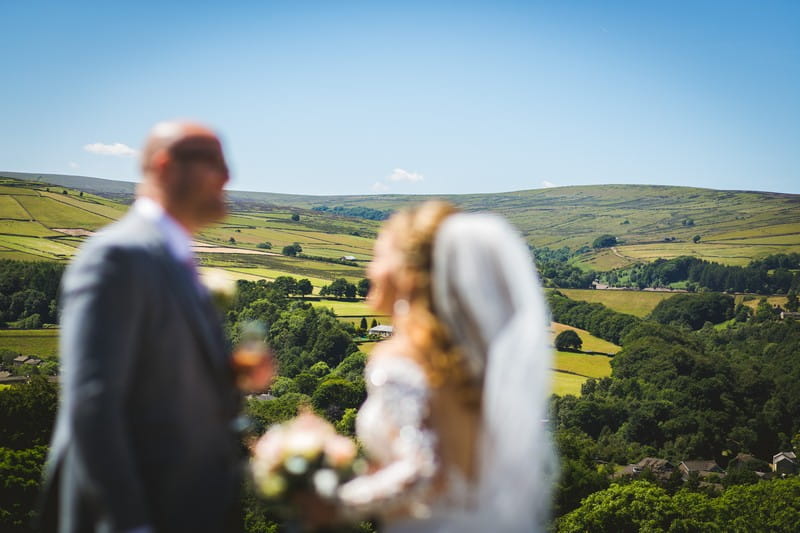 Bride and groom with hills of Holme Valley in background