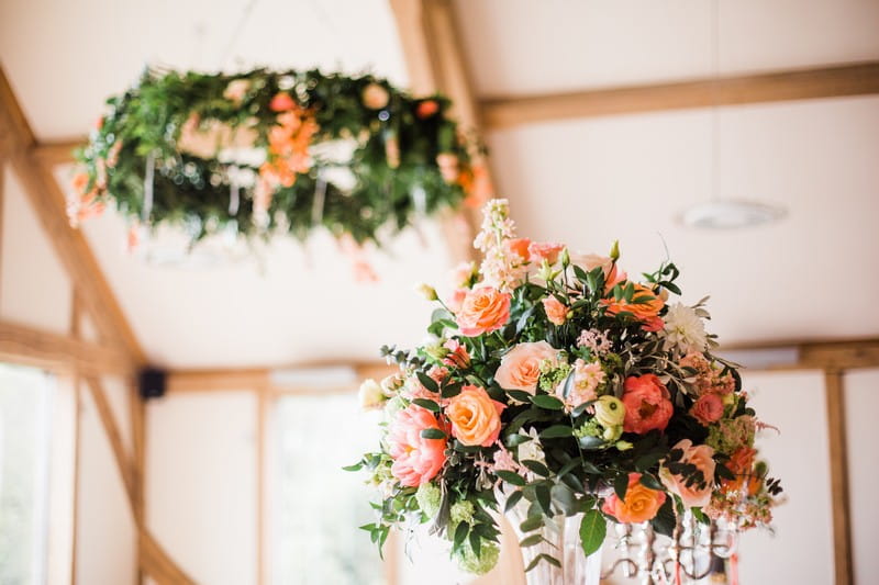 Coral coloured wedding table flowers
