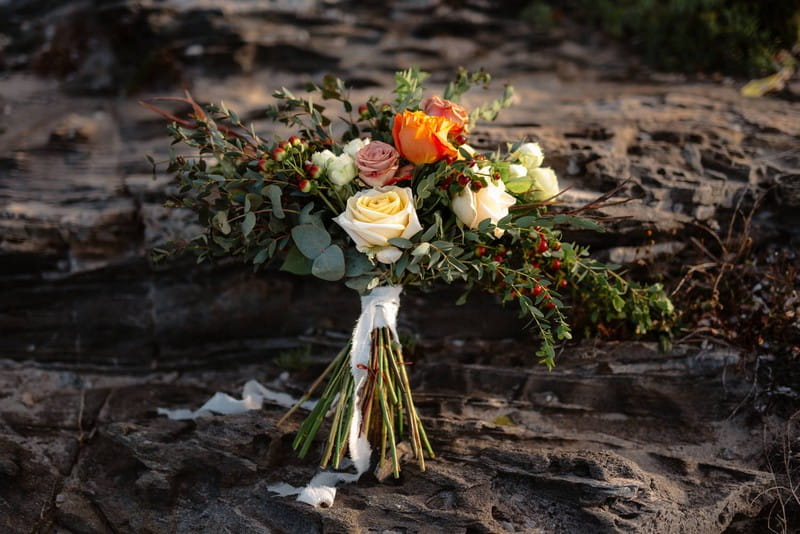 Bridal bouquet with orange, cream and blush flowers