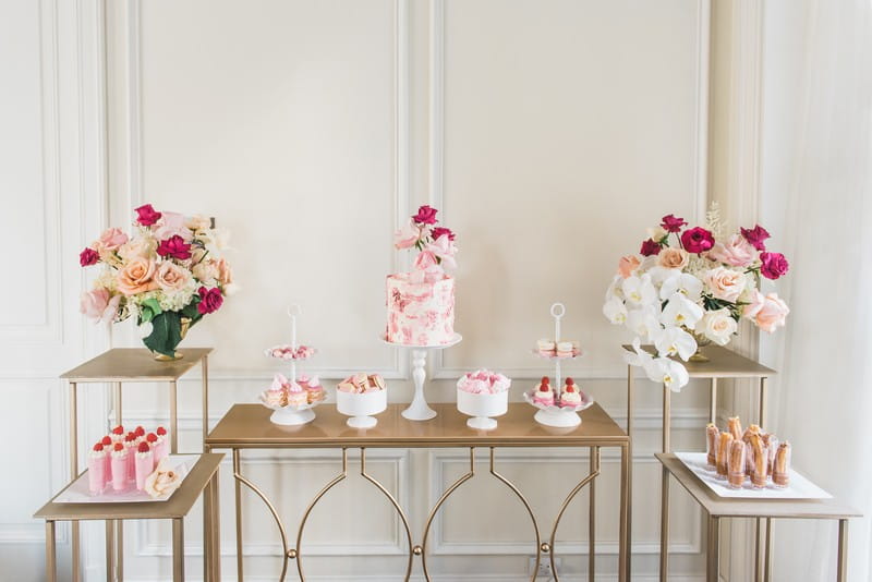 Gold dessert tables with pink flower displays