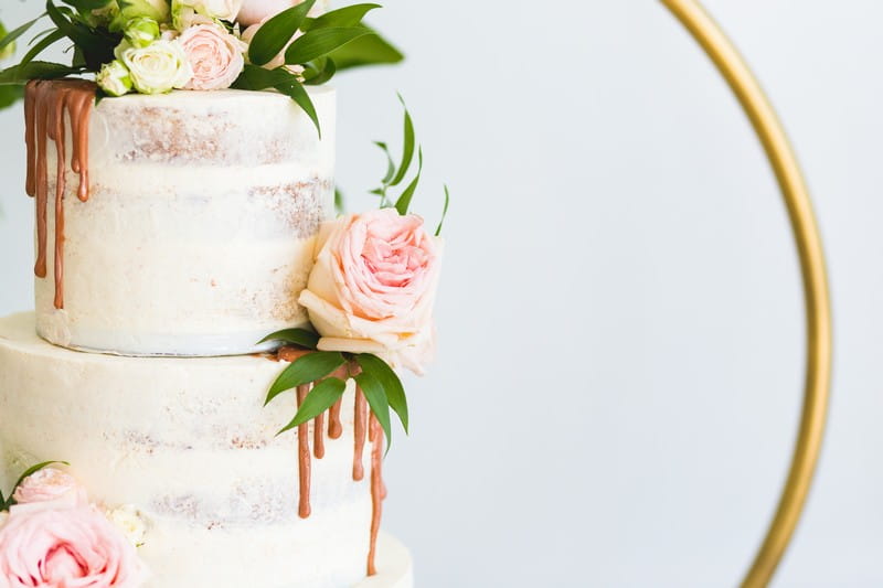Pink rose on side of wedding cake