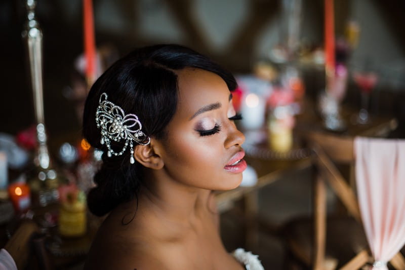 Bride wearing hair accessory with eyes shut