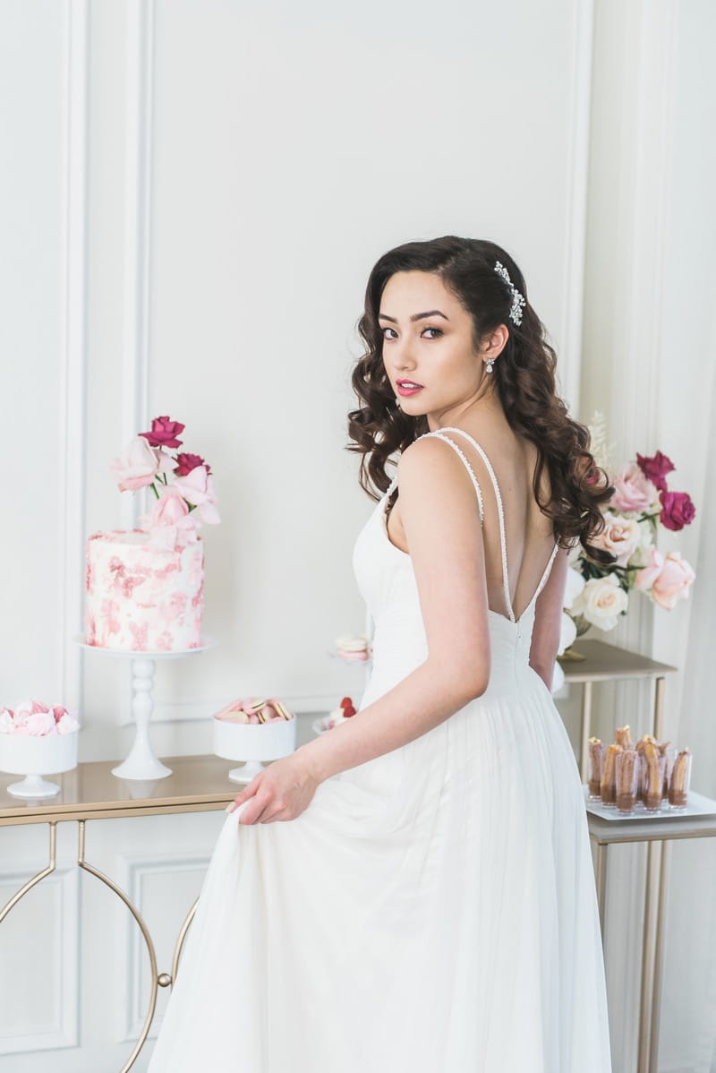 Bride standing in front of dessert table