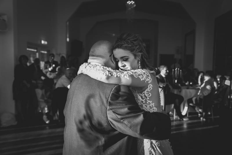 Bride hugging father on dance floor