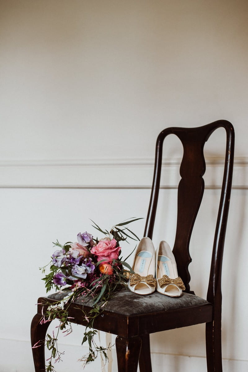 Bridal shoes and bouquet on chair