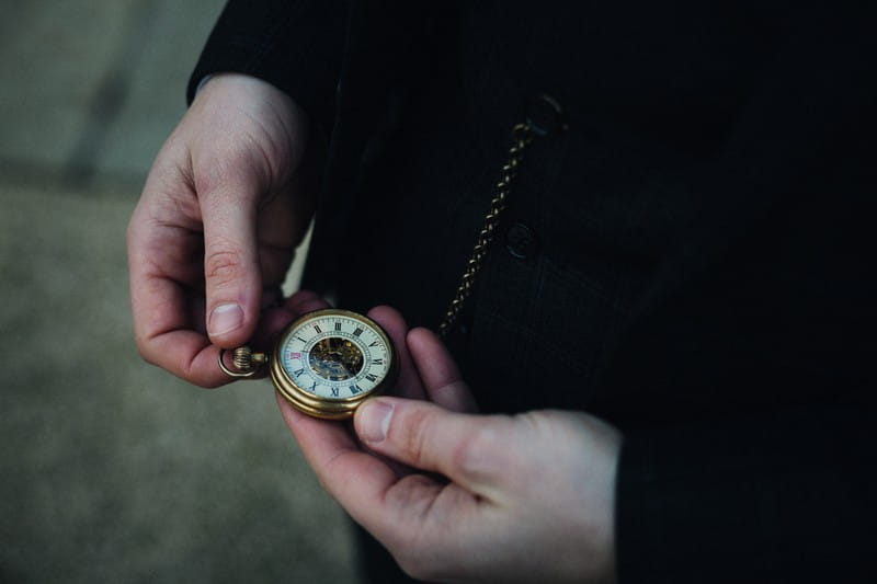 Checking time on pocket watch