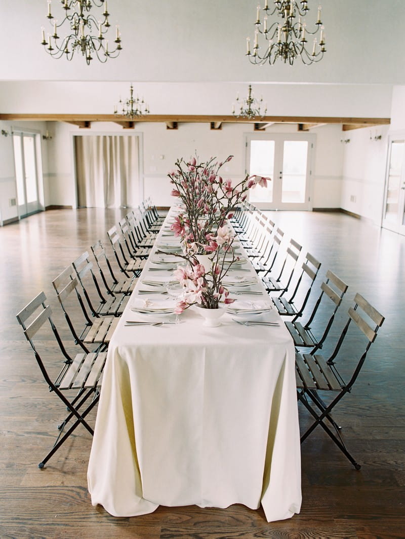 Long wedding table styled with pink magnolia