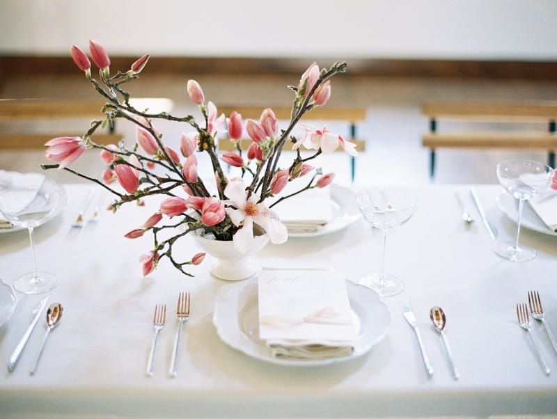 Wedding place setting with pink and white magnolia flowers