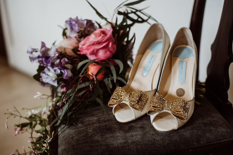 Charlotte Mills bridal shoes on chair next to bouquet