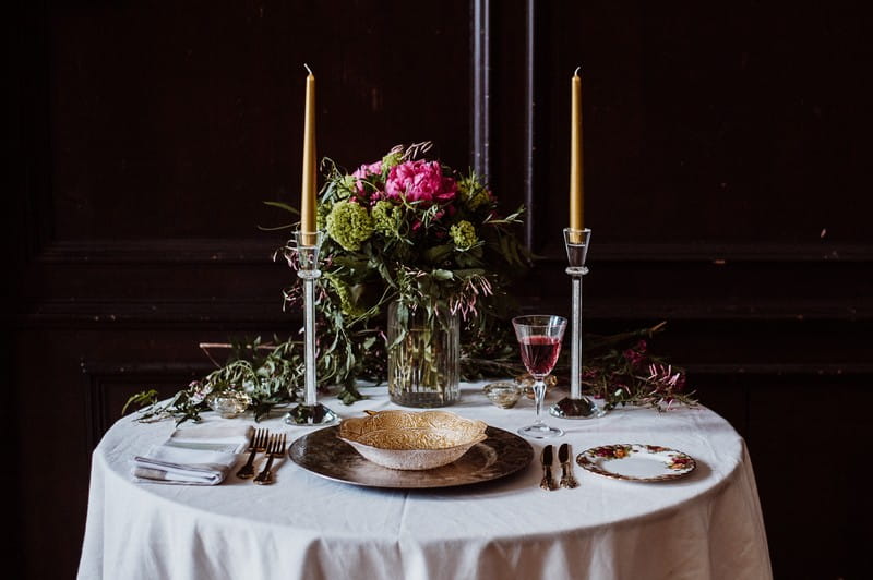 Small wedding table with tall candles and floral centrepiece