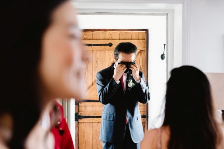 Emotional groom wiping tears from his eyes with a handkerchief - Picture by Fiona Kelly Photography