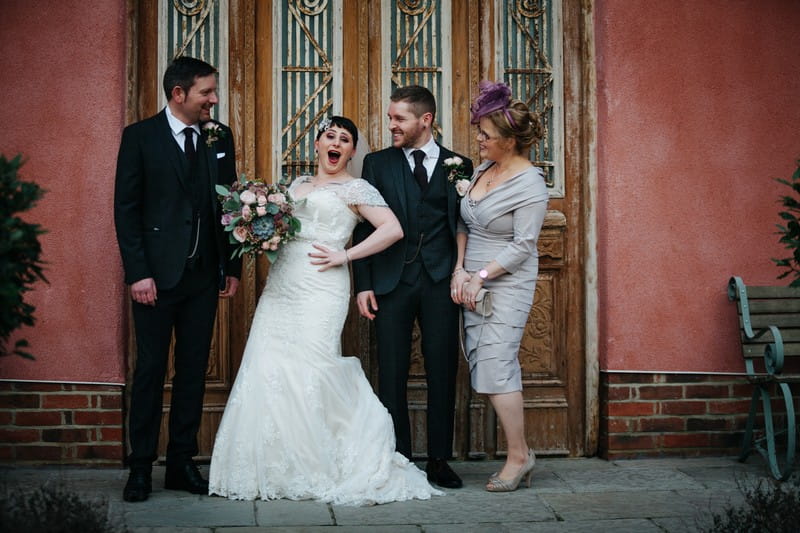Bride with hand on hip during formal photographs