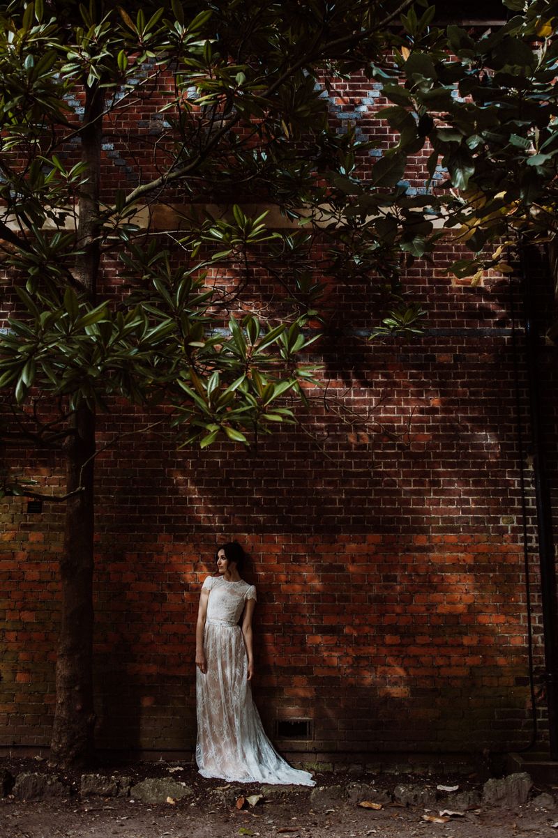 Bride standing next to a wall at Fulham Palace