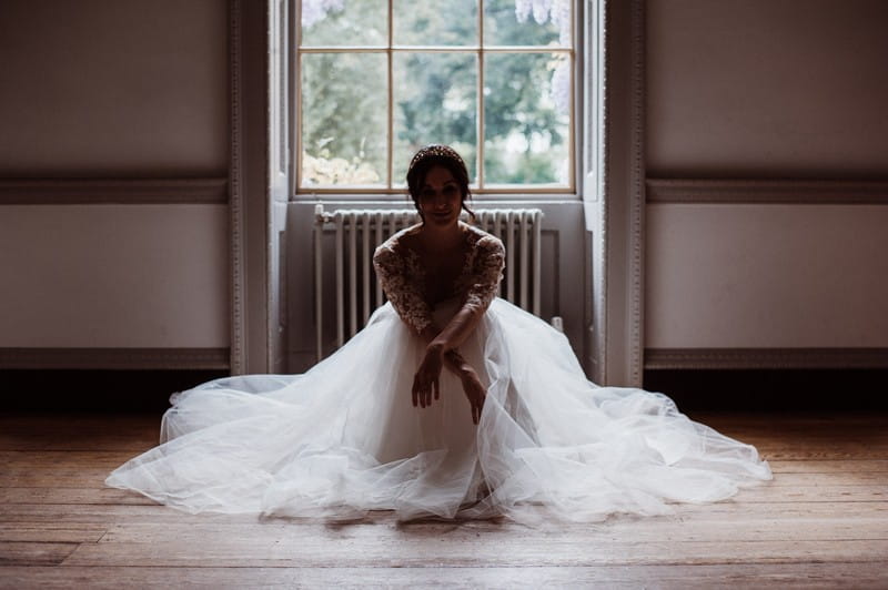 Bride sitting on floor at Fulham Palace