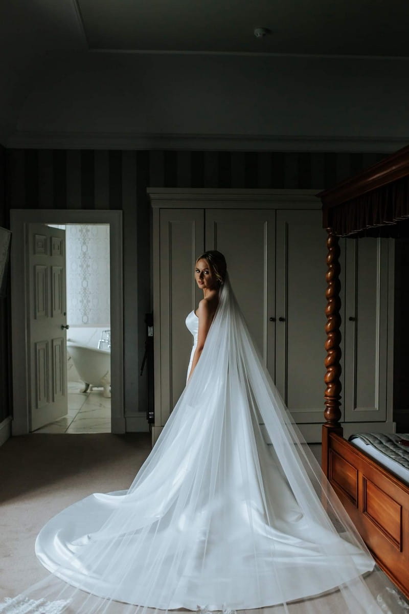 Bride wearing wedding dress with long train and veil - Picture by Rebecca Rose Noller Photography