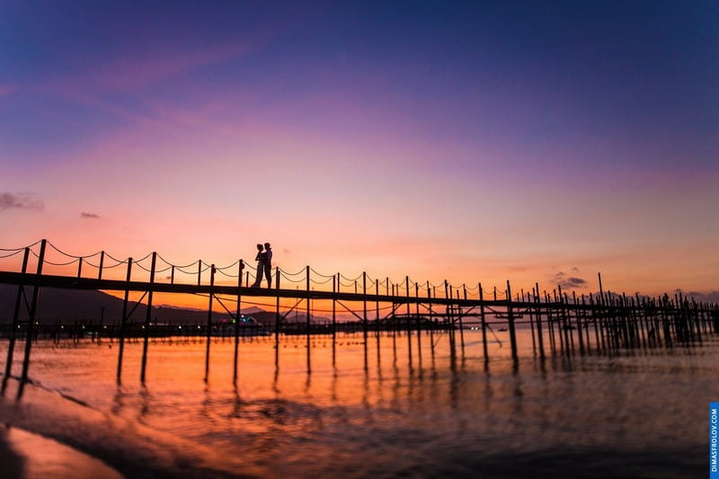 Bride and groom on bridge at sunset - Picture by Dimas Frolov Photography