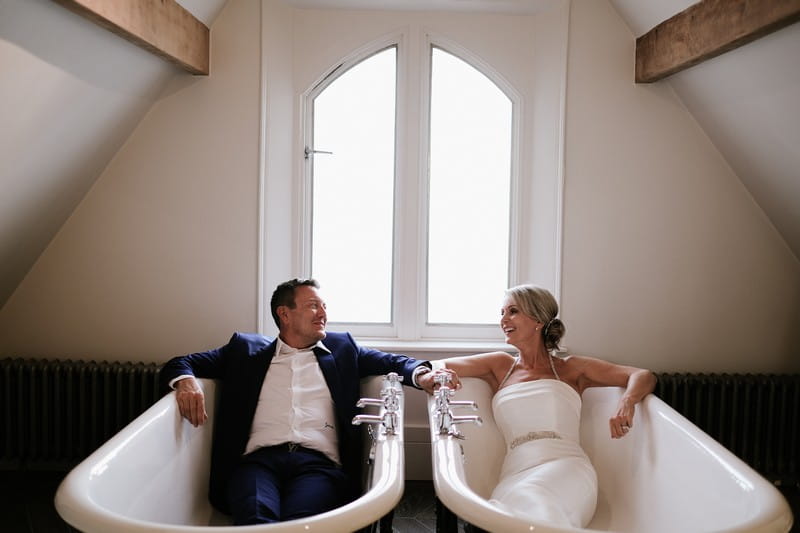 Bride and groom sitting in bathtubs - Picture by Rebecca Parsons Photography