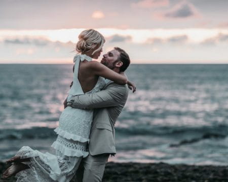 Groom lifting bride up on the beach - Picture by Ben Wigglesworth Photography