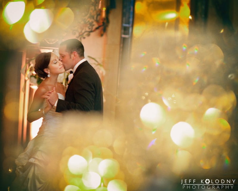 Groom kissing bride on cheek - Picture by Jeff Kolodny Photography