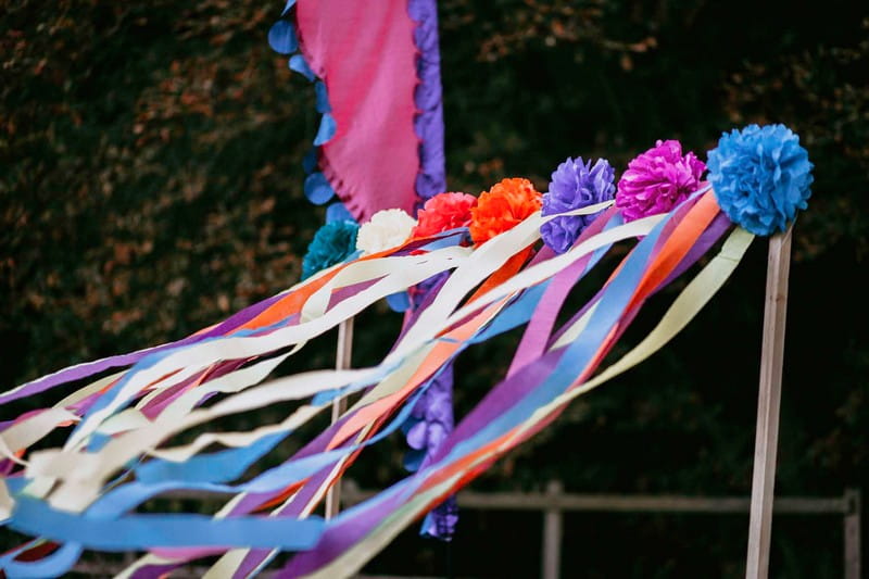 Colourful paper pom poms and streamers