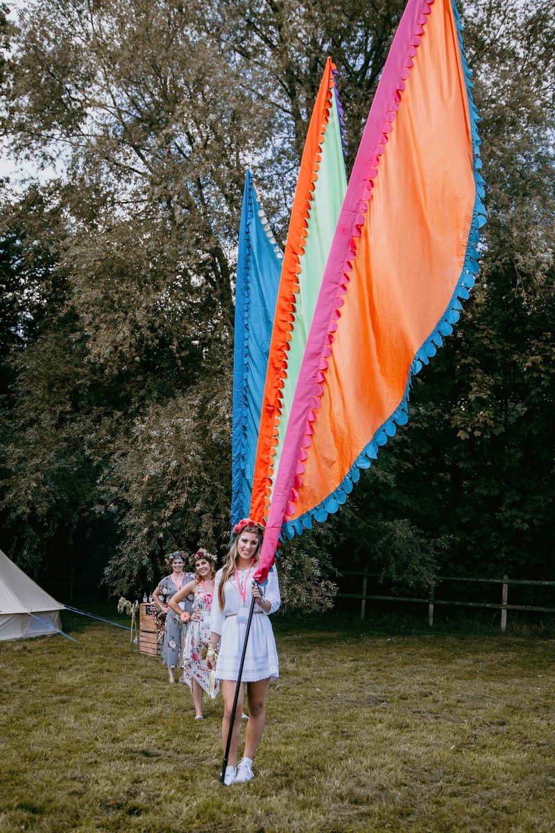 Girls at hen party holding large festival flags