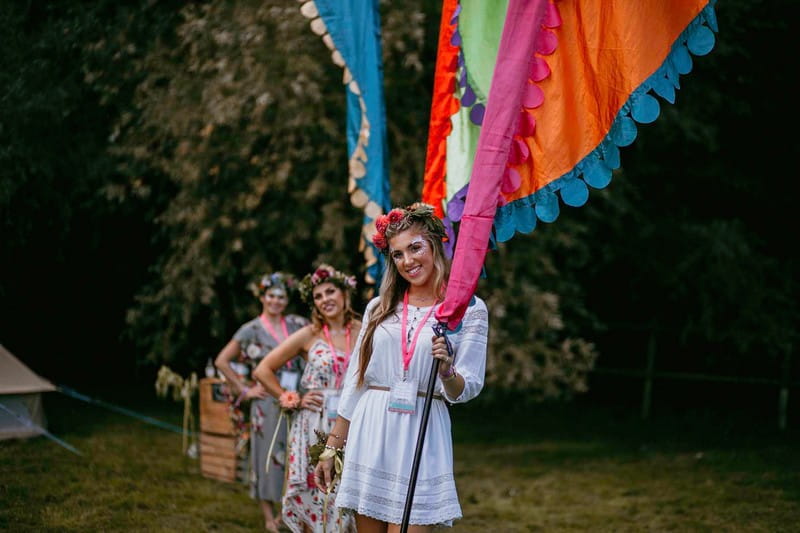 Girls at hen party holding colourful festival flags