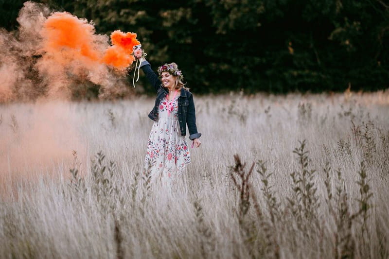 Girl holding orange smoke bomb