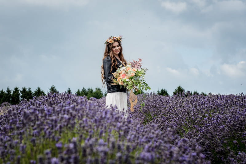 Bride wearing leather jacket in lavender field