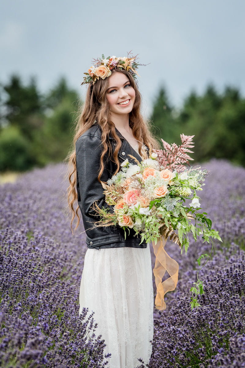 Bride wearing leather jacket and flower crown in lavender field